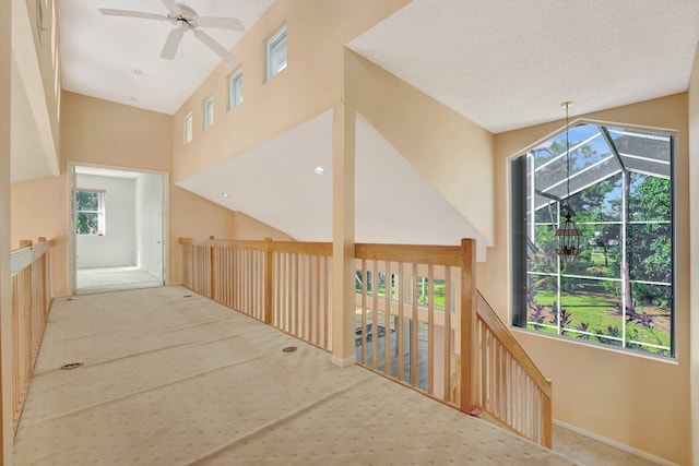 corridor featuring light colored carpet and vaulted ceiling