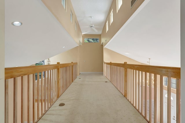 hall featuring light carpet and lofted ceiling