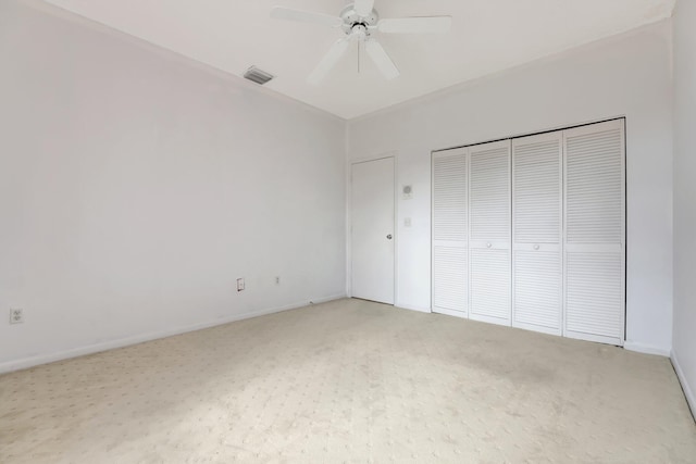 unfurnished bedroom featuring carpet flooring, a closet, and ceiling fan