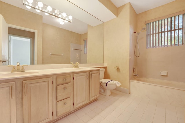 full bathroom featuring vanity, tiled shower / bath combo, toilet, and tile patterned floors