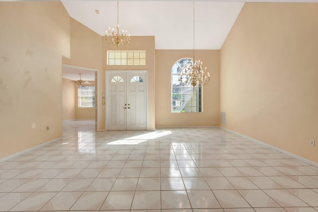 entryway featuring high vaulted ceiling, ceiling fan with notable chandelier, and light tile patterned floors