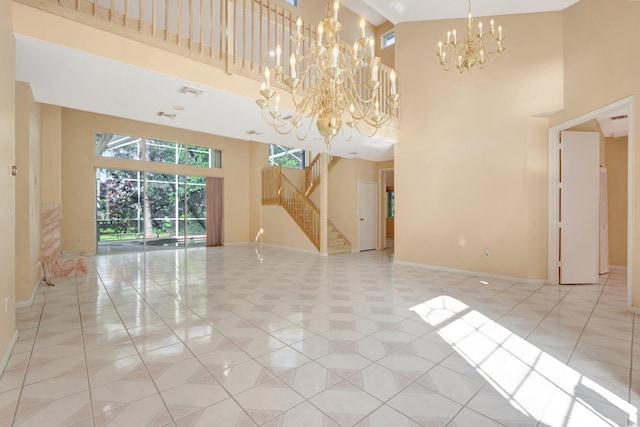 tiled empty room featuring a towering ceiling and a chandelier