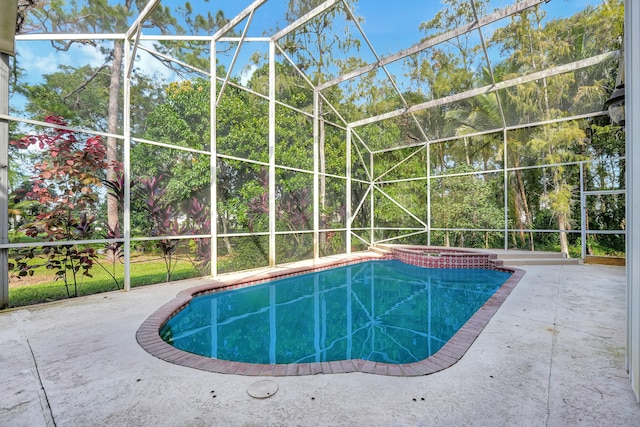 view of swimming pool with a patio area, a lanai, and an in ground hot tub