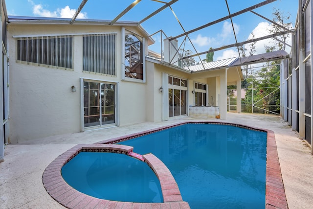 view of pool featuring a patio, a lanai, and an in ground hot tub