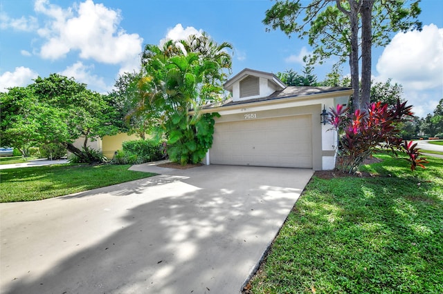 view of front of property featuring a garage and a front lawn