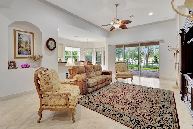 tiled living room featuring ceiling fan with notable chandelier