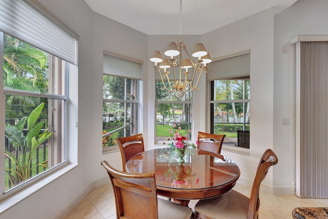 dining area featuring a chandelier, plenty of natural light, and light tile patterned floors