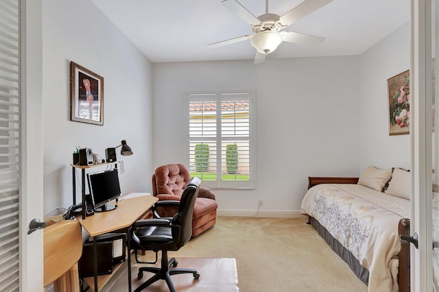 carpeted office space featuring ceiling fan