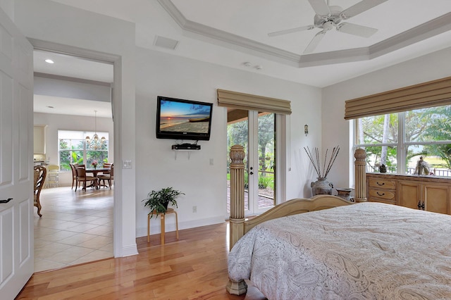 bedroom with ornamental molding, ceiling fan with notable chandelier, light wood-type flooring, and access to outside