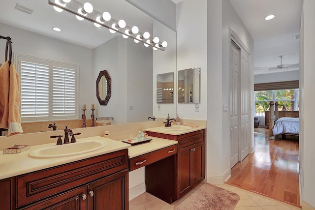 bathroom featuring vanity, hardwood / wood-style floors, and ceiling fan