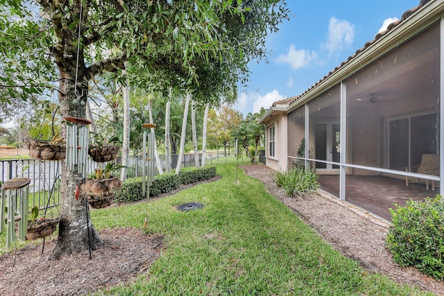 view of yard featuring a patio and a sunroom