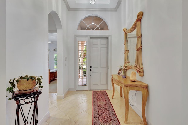 entrance foyer with ornamental molding and light tile patterned floors