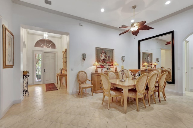 dining room with crown molding, light tile patterned floors, and ceiling fan