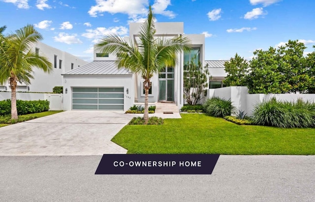 view of front of property featuring a garage and a front lawn