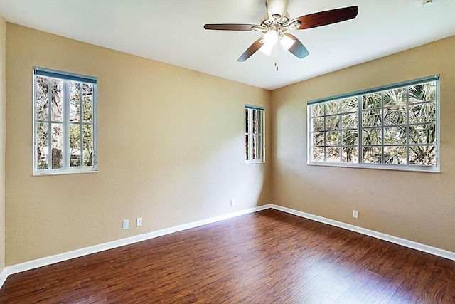 empty room featuring ceiling fan and dark hardwood / wood-style floors