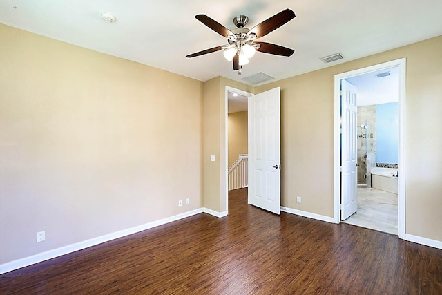 unfurnished bedroom with dark wood-type flooring, ceiling fan, and ensuite bathroom