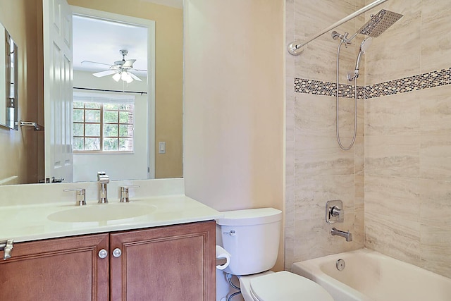 full bathroom featuring ceiling fan, toilet, vanity, and tiled shower / bath combo