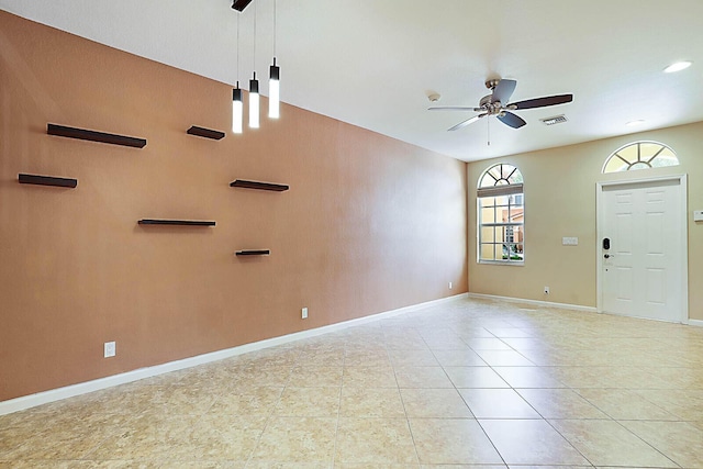 interior space with ceiling fan and light tile patterned floors