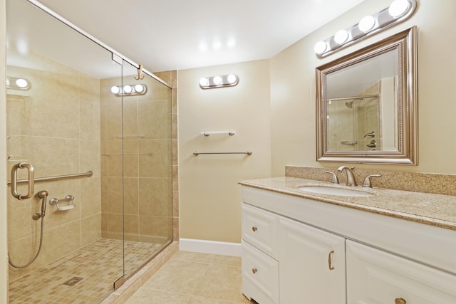 bathroom with vanity, tile patterned flooring, and walk in shower