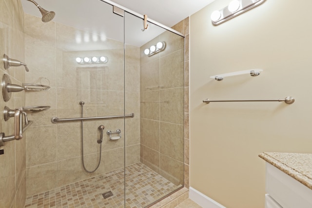 bathroom with a shower with door and vanity