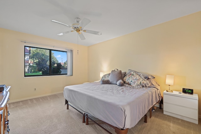 bedroom featuring light carpet and ceiling fan