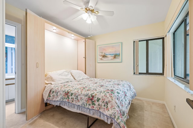 bedroom featuring light carpet and ceiling fan