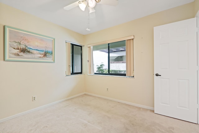 carpeted empty room with ceiling fan