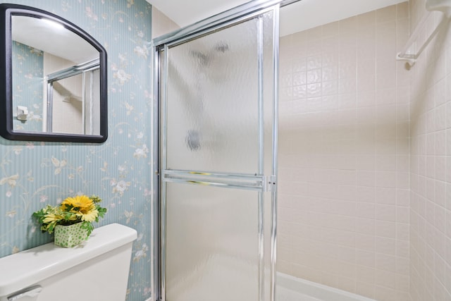 bathroom featuring toilet and walk in shower