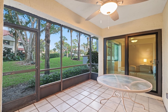 unfurnished sunroom featuring ceiling fan