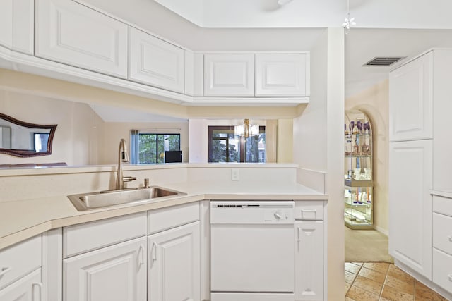 kitchen featuring sink, light carpet, white cabinetry, and dishwasher