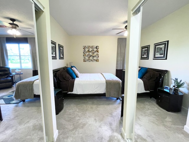 carpeted bedroom featuring a textured ceiling and ceiling fan