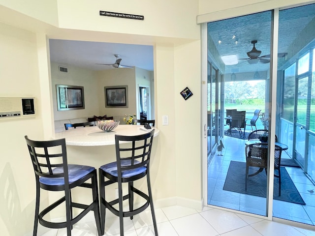 dining room with light tile patterned flooring and ceiling fan