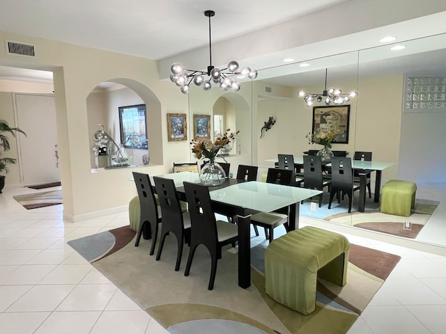 dining room with light tile patterned flooring and a notable chandelier