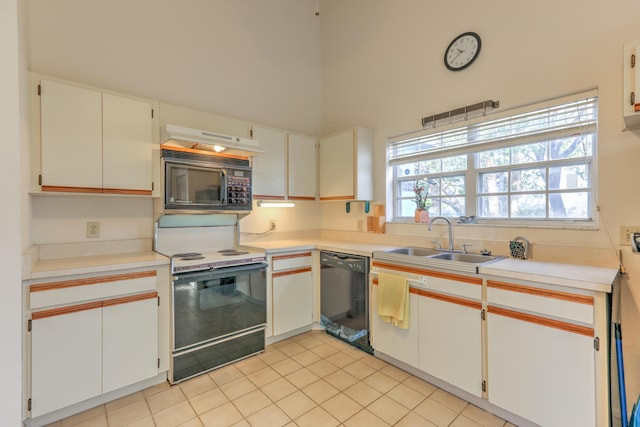 kitchen featuring sink, plenty of natural light, black appliances, and white cabinets