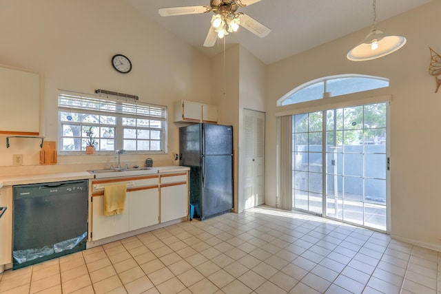 kitchen featuring light tile patterned flooring, white cabinetry, sink, hanging light fixtures, and black appliances