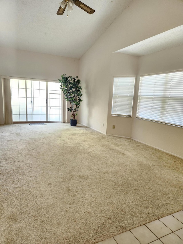 carpeted spare room featuring a textured ceiling and ceiling fan