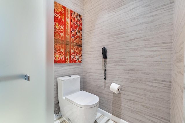 bathroom with tile walls and toilet