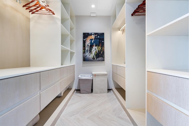 spacious closet with light parquet flooring