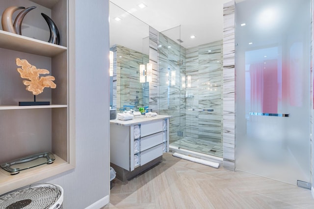 bathroom with a shower with door and vanity