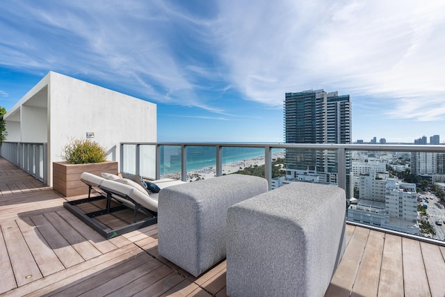 deck with a water view and a view of the beach