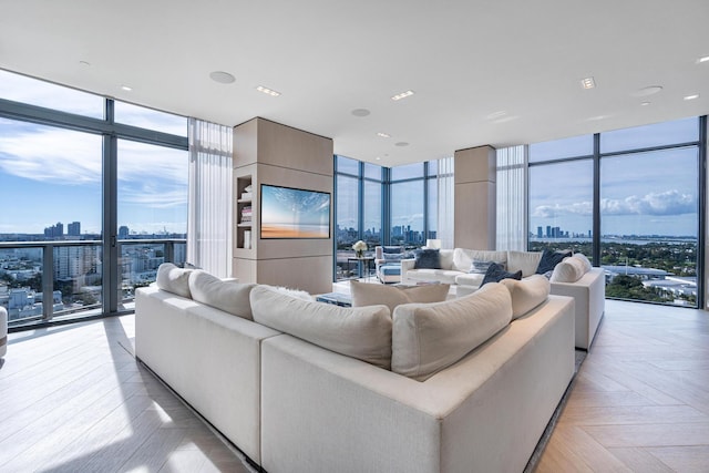 living room featuring light parquet floors, expansive windows, and a wealth of natural light