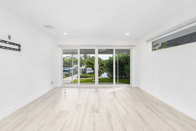 spare room with light hardwood / wood-style floors