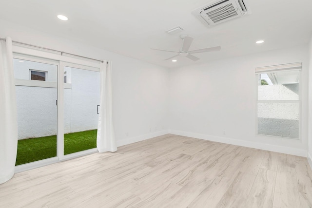 empty room featuring ceiling fan and light hardwood / wood-style floors