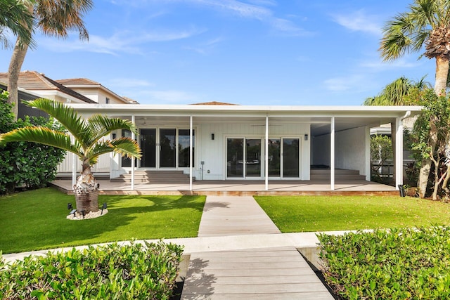 rear view of property featuring a patio and a lawn