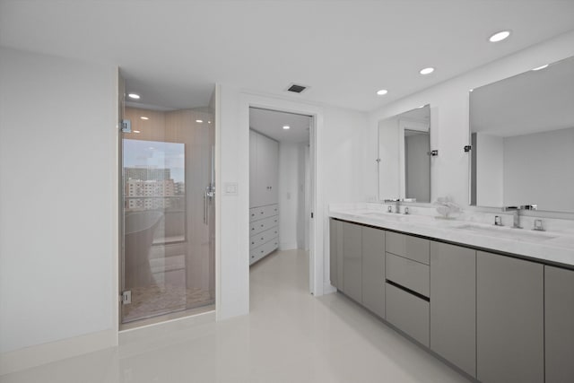 bathroom with vanity and a shower with shower door