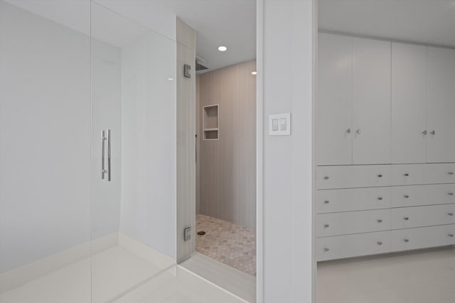 bathroom featuring a shower with shower door