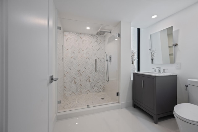 bathroom featuring vanity, toilet, and an enclosed shower