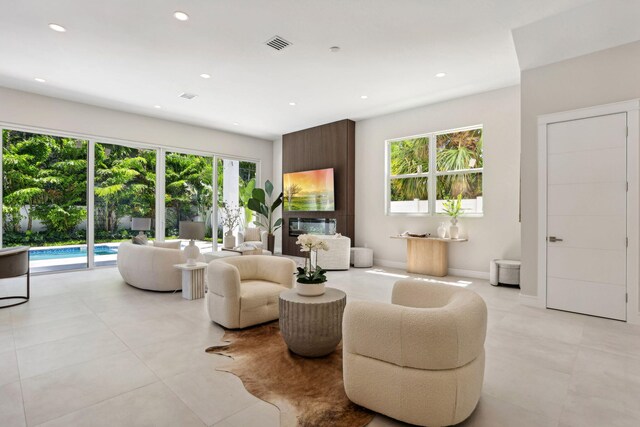 living room with recessed lighting and light tile patterned flooring
