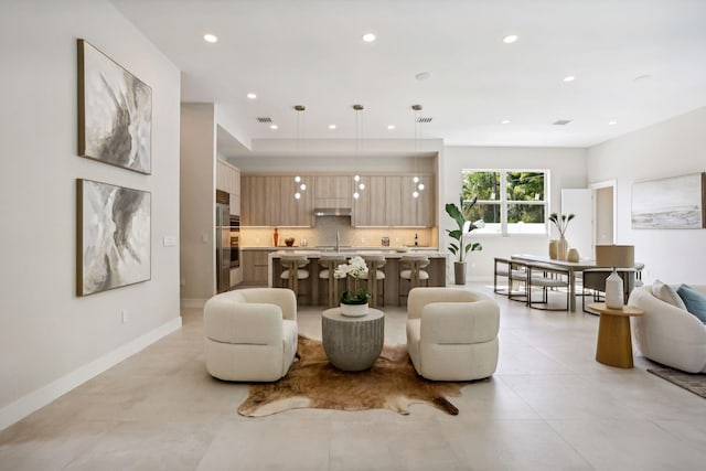 living area featuring recessed lighting, baseboards, and light tile patterned floors