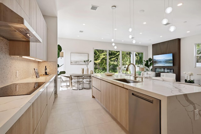 kitchen with pendant lighting, dishwasher, black electric stovetop, sink, and range hood